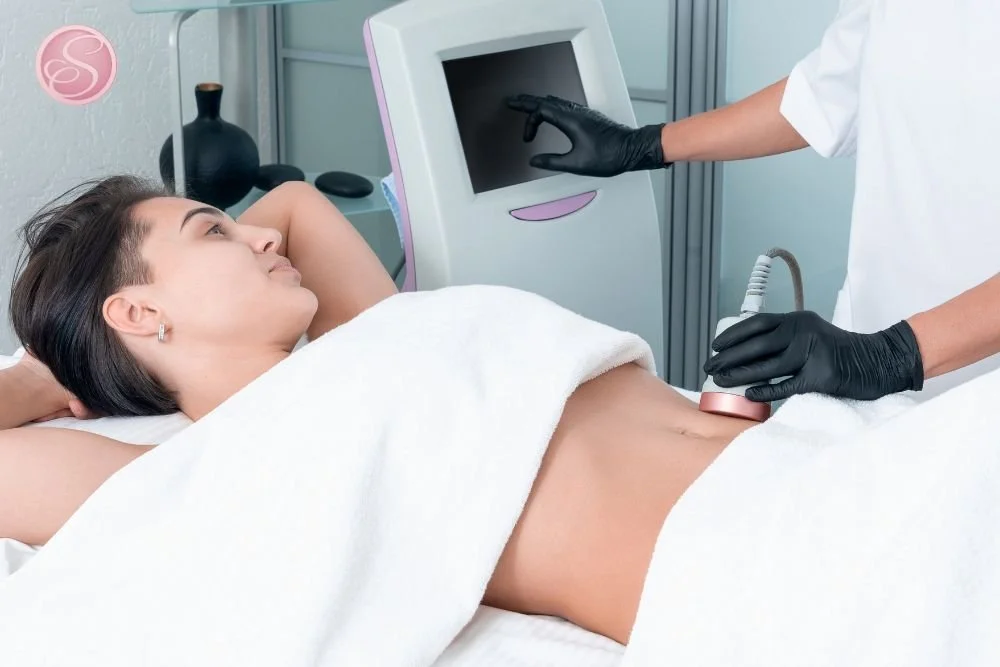 Body contouring specialist assessing treatment zones with careful measurement and planning